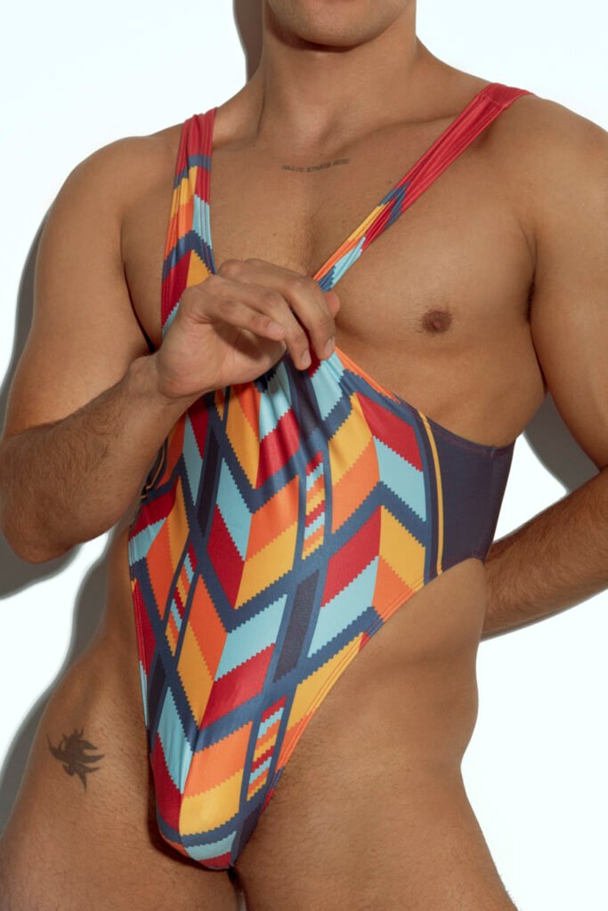 Men's high-cut swim bodysuit with orange and teal geometric pattern, designed for gay men seeking bold and fashionable swimwear