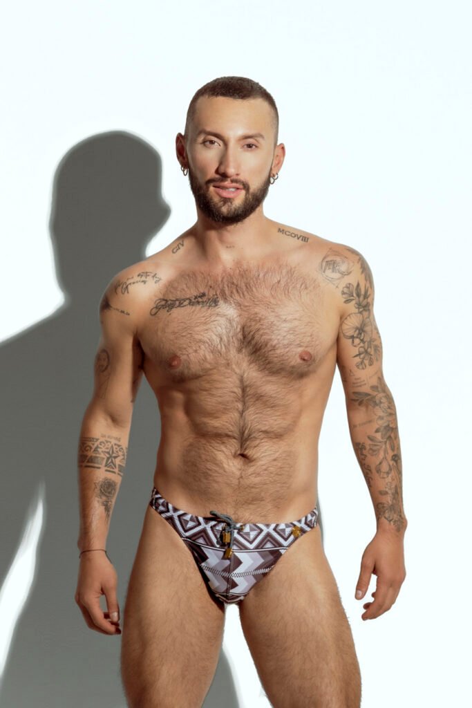 Men's thong with tribal geometric print in neutral tones, designed for gay men seeking bold and sexy swimwear