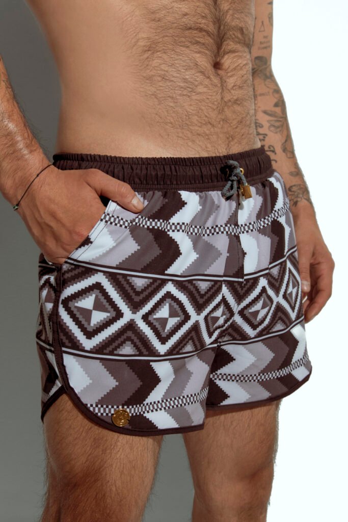 Men's swim short with tribal geometric print in neutral tones, designed for gay men seeking bold and sexy swimwear