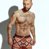 Men's swim short featuring a bold zigzag pattern in red, orange, and yellow, ideal for gay men seeking stylish and eye-catching swimwear