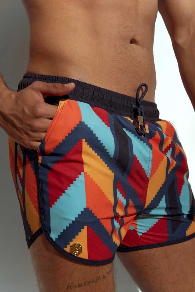 Men's swim short with vibrant multicolor abstract pattern, perfect for gay men who love bold and unique beachwear