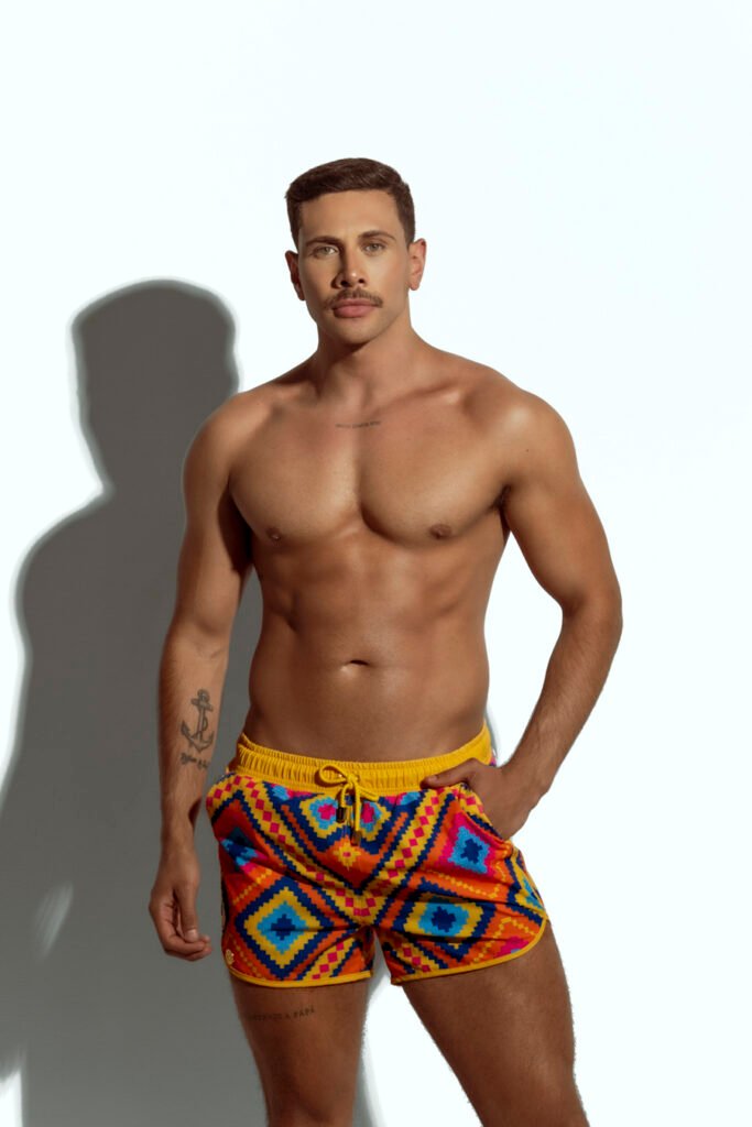 Men's swim short with colorful geometric pattern, ideal for gay men seeking bold and stylish beachwear