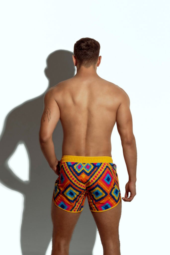 Men's swim short with colorful geometric pattern, ideal for gay men seeking bold and stylish beachwear