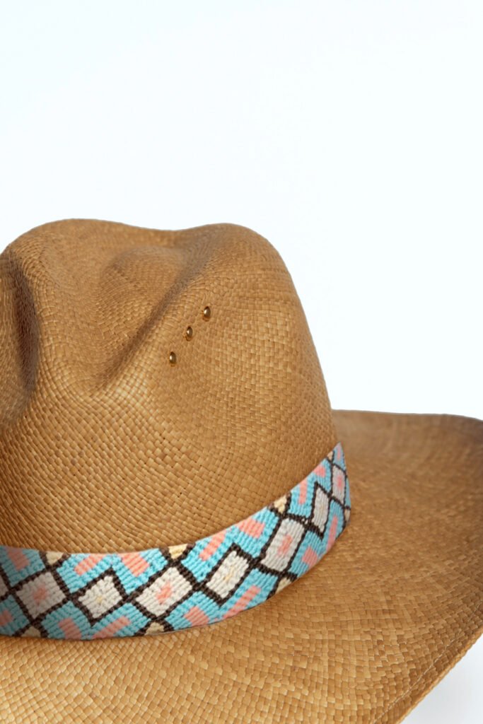 Handmade straw hat with vibrant Wayuu band by Colombian artisans. Perfect for beach, poolside relaxation, or summer cocktails. Stylish and unique